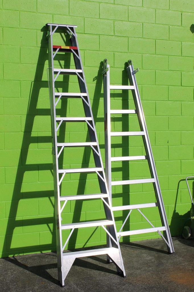 Vergelijking van een moderne aluminium trap naast een traditionele houten trap voor gebruik op de bouwplaats